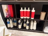 many bottles of lotion on the shelf in the bathroom