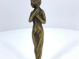 vintage brass figurine of a woman holding her hands to her face