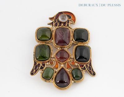 une image représentant une broche composée de pierres de différentes couleurs sur un fond blanc