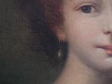 portrait of a young girl in a white dress with a flower in her hair