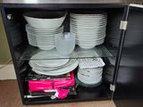 a black cabinet with plates and bowls in it