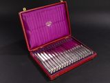 a red case with silverware in it on a black surface