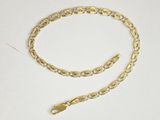 a close up of a gold chain on a white surface