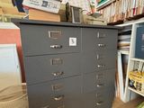 un classeur dans un coin d'une pièce où se trouvent de nombreux livres