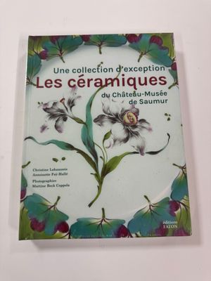the cover of a book with flowers on it on a white surface