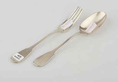 two forks and spoons with labels on them sitting on a table