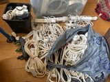 a lot of cords, cords, and other electronics on the floor