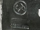 a close up of a metal object with a hammer on it