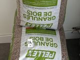 two bags of rice sitting next to each other on the floor