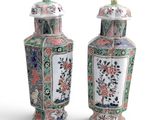 pair of chinese vases with flowers and birds painted on them