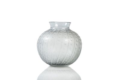 a glass vase sitting on top of a white table