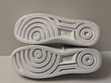 the soles of a pair of white sneakers on a white surface