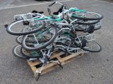 many bikes that are sitting on a pallet in the parking lot