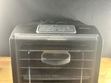 a toaster oven sitting on top of a wooden table