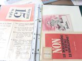 a book open on a table with papers on it