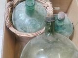 a box with two glass bottles in it and a basket with two bottles in it