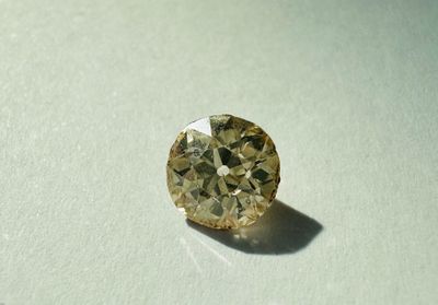 a yellow diamond that is sitting on a table