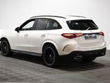 the rear end of a white mercedes suv parked on a checkered floor