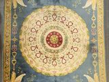 an image of a blue rug with birds and flowers on it