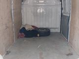 a white van with a mattress in the back of it