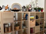 a room with a lot of shelves and pots on top of it