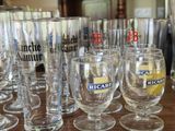 many wine glasses lined up on a table