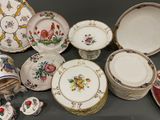 many different types of plates and bowls on the table