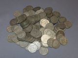a pile of silver coins sitting on a table