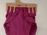 purple ribbed diaper cover with wooden hanger on a white background