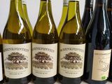 several bottles of wine are lined up on a table