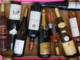 many bottles of wine in a pink box on the table