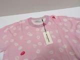 a pink t - shirt with lipstick print on it