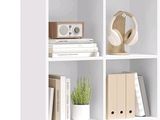 a white bookcase filled with books and a plant