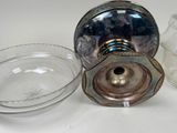 a glass container and a glass bowl sitting on a table