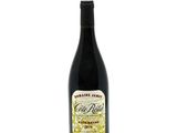a bottle of wine sitting on top of a white table