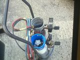 a small air compressor on the ground next to a truck