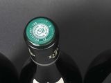 six bottles of wine are lined up in a row on a table