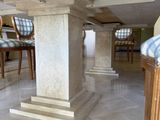 an image of a dining room with a marble table and chairs