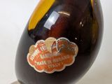 a glass vase with a brown liquid inside of it