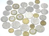 a lot of coins that are on a white surface