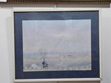 two framed pictures on the wall of a room