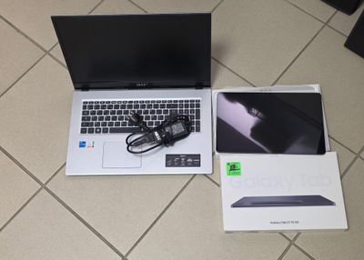 a laptop computer sitting on the floor next to a box