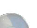 a white bowl with a blue rim sitting on a table