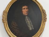 portrait of a man in a gold frame with a white collar