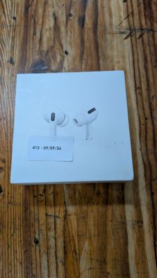 an apple airpods are sitting on top of a box on a wooden table