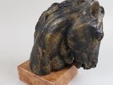 sculpture of a horse head on a wooden base