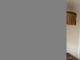 a bed and a lamp in a room with white walls