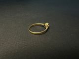 a close up of a gold ring on a black surface