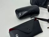 glasses and a case are sitting on a table next to a pair of eyeglasses