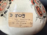 a vase with a tag on it sitting on a table